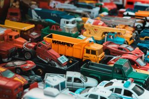 A vibrant assortment of vintage toy cars displayed at a market in Dol-de-Bretagne, France.
